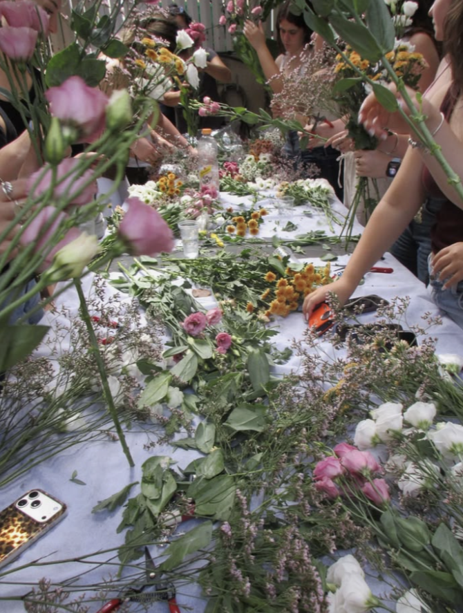 A long table covered in fresh flowers during a bouquet workshop