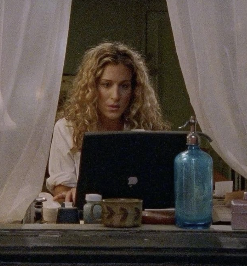 A woman writing on her laptop at home
