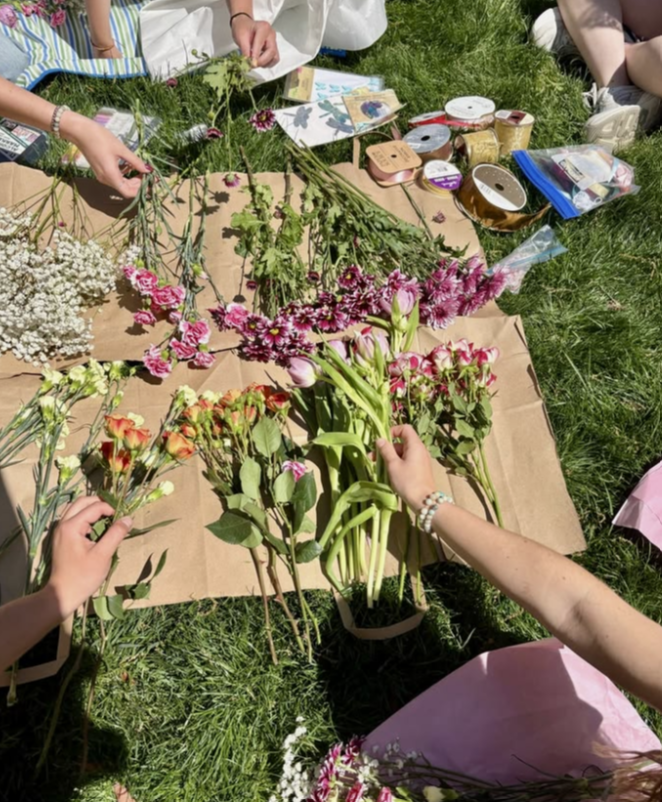Sorting fresh flowers on a blanket outdoors
